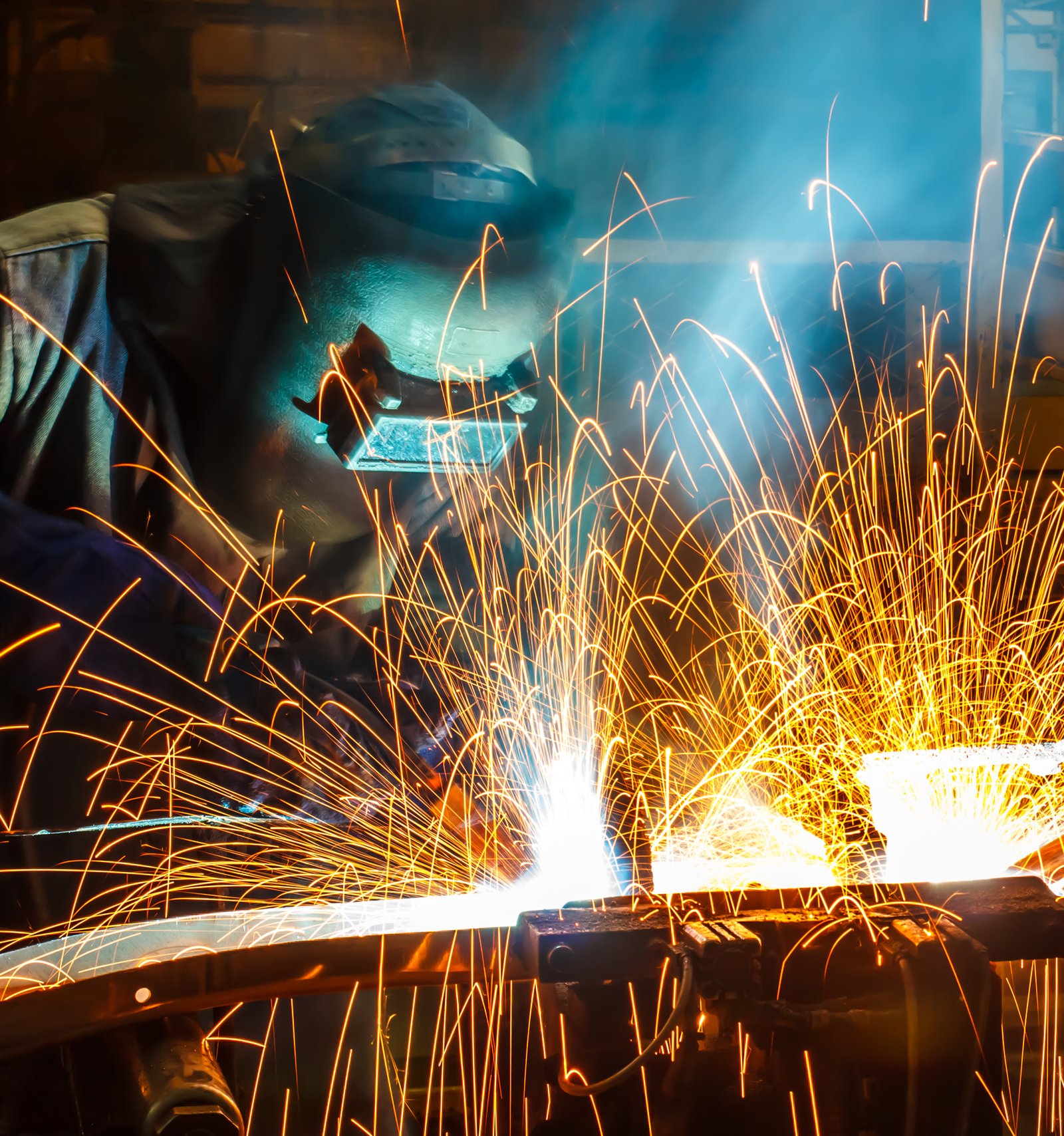Commercial welder working on steel beams